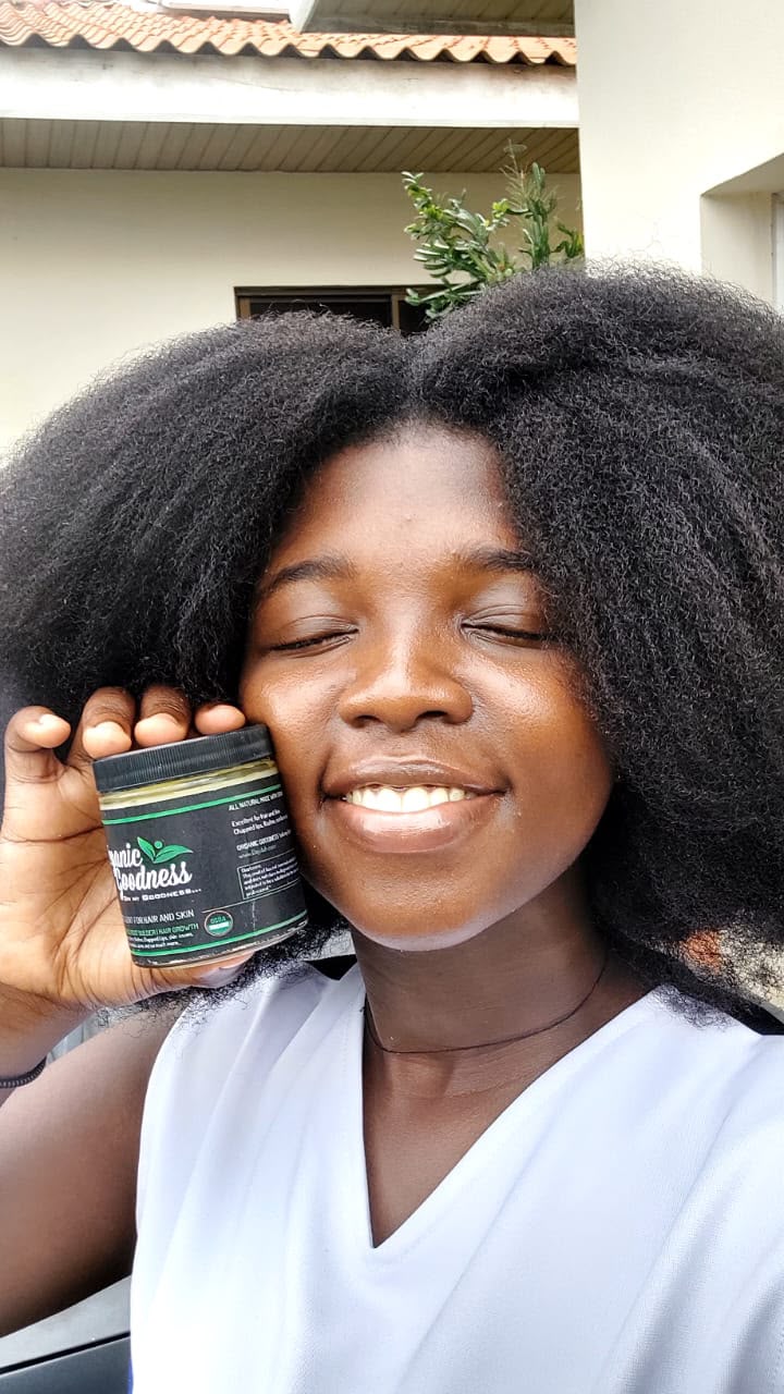 Customer displaying Organic Goodness beside her natural hair