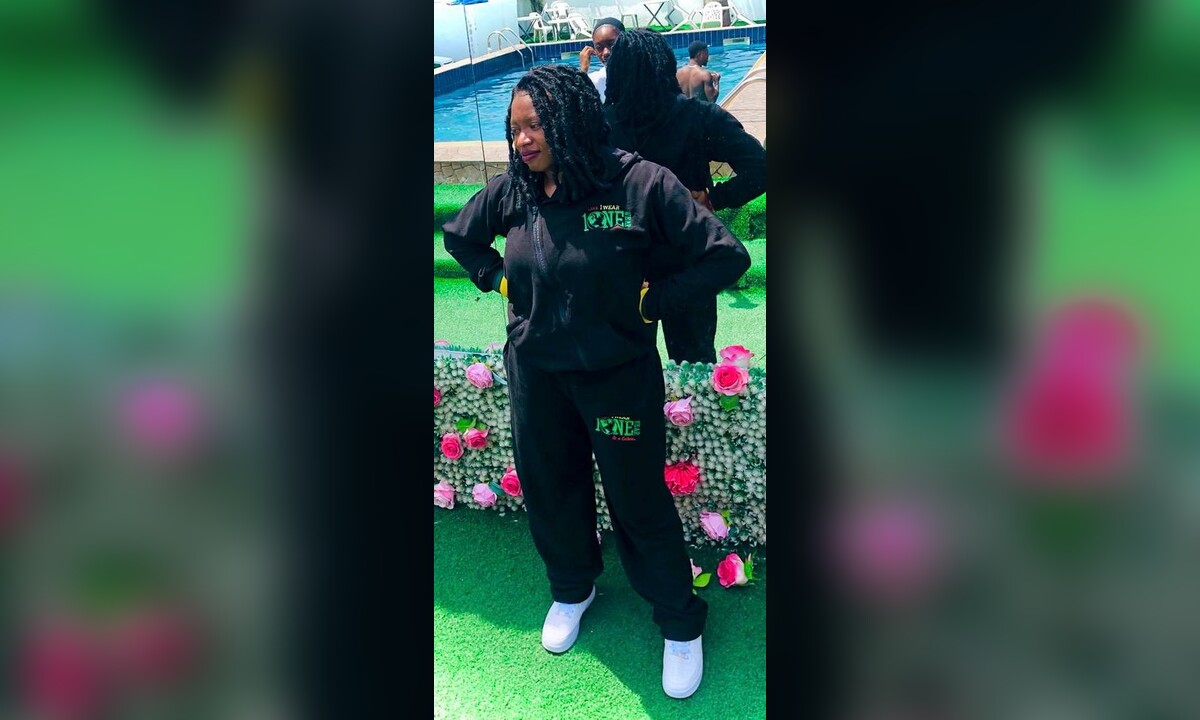 Model wearing a black One Wear tracksuit
