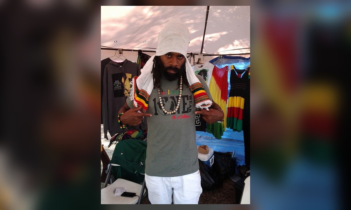 One Wear creator wearing a grey One Wear shirt at a cultural market