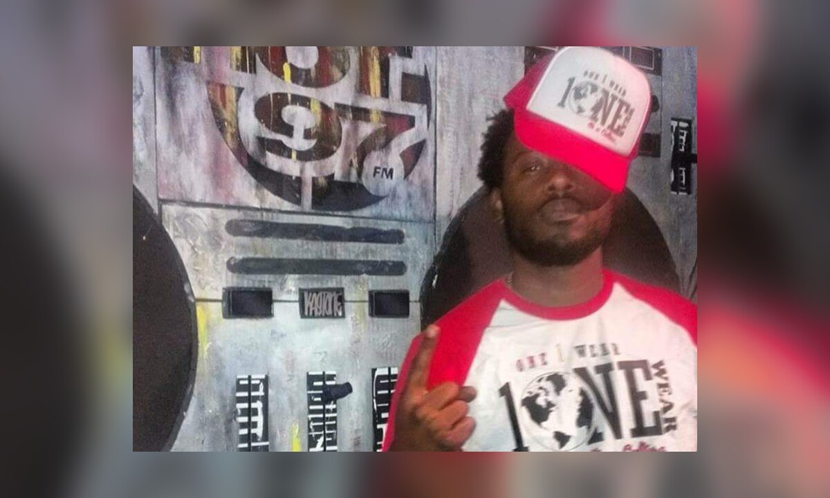 One Wear creator wearing a red-and-white One Wear shirt and cap