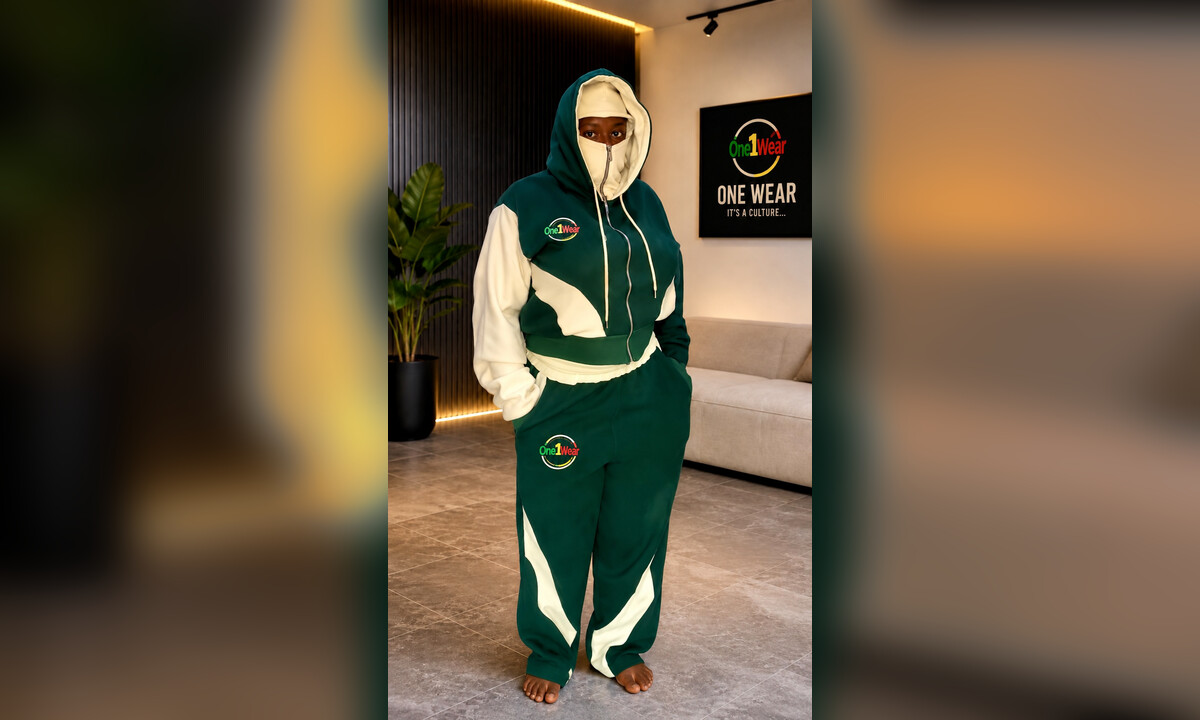 Model wearing a green-and-cream One1Wear tracksuit with matching branded logos